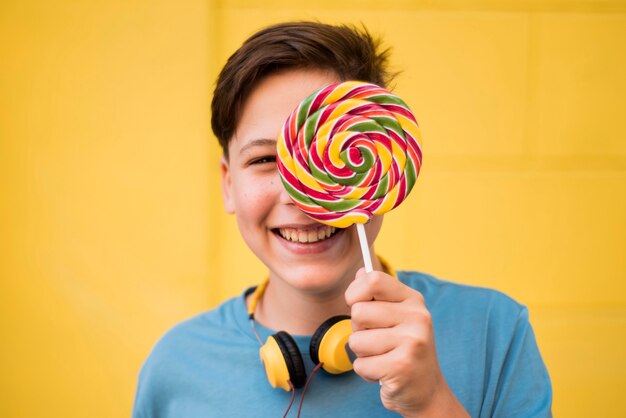 Teenager holding lolipop