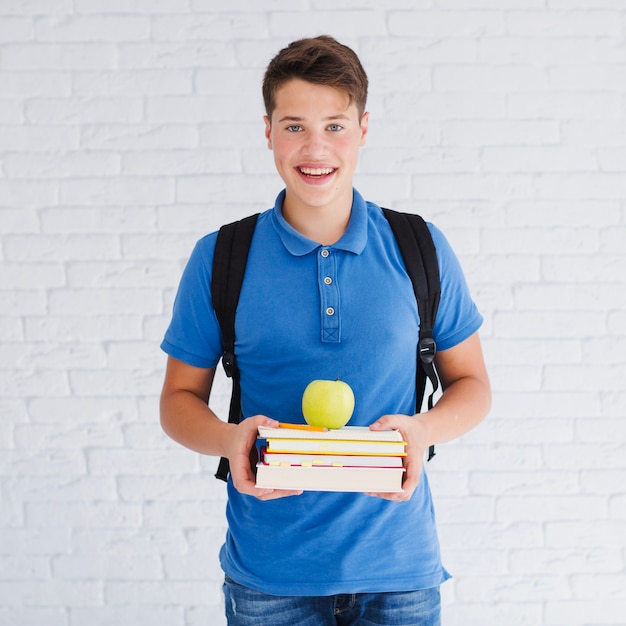 Teenager holding textbooks