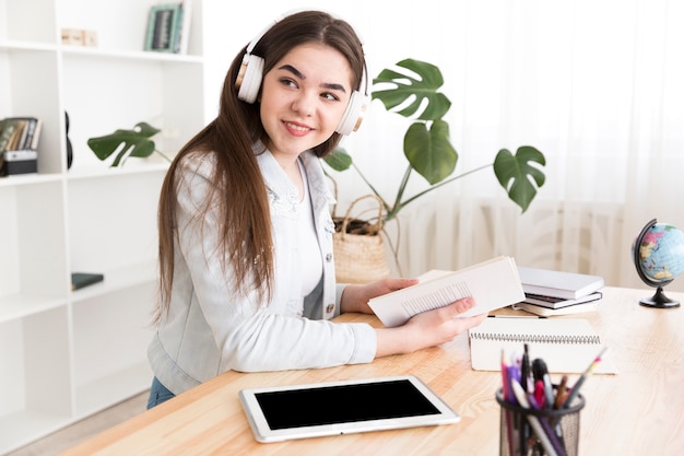 Teenager listening to music while studying