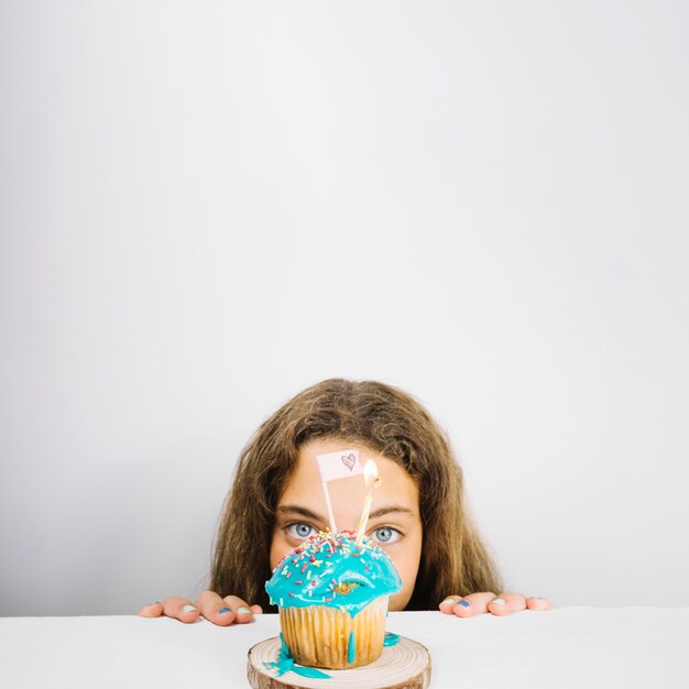 Teenager looking at cupcake