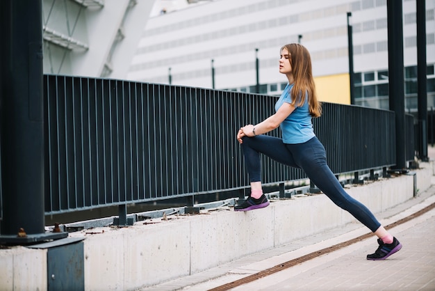 Teenager lunging near fence