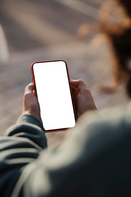 Teenager outdoors using smartphone