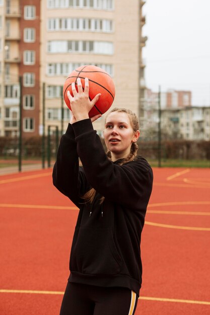 Teenager playing basketball outdoors