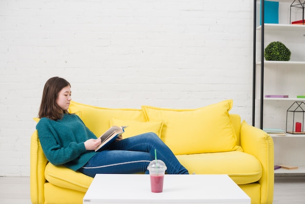 Teenager reading on couch