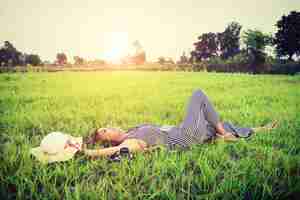 Free photo teenager resting on the lawn with a camera