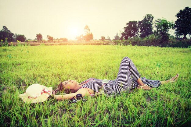 Teenager resting on the lawn with a camera