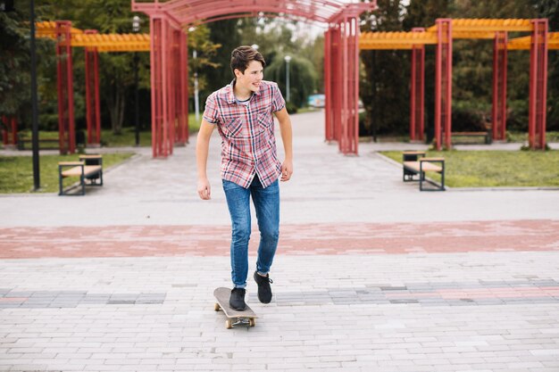 Teenager skateboarding in front of arch