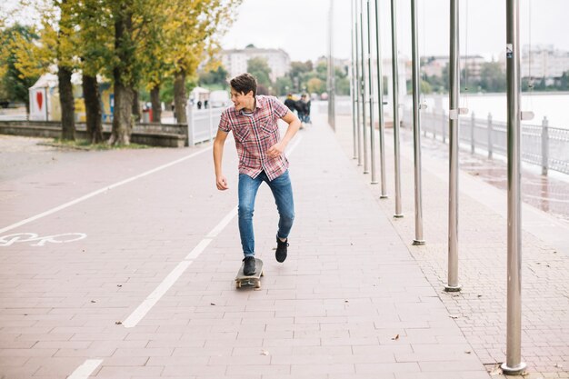 Teenager skateboarding near bike lane