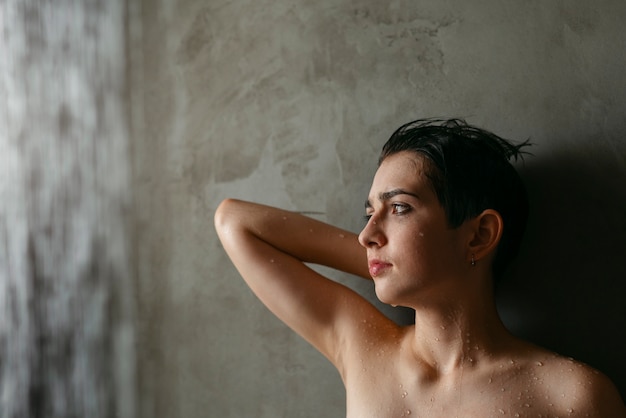 Free photo teenager taking a shower to reduce hangover effect