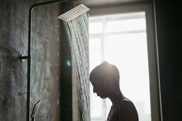 Teenager taking a shower to reduce hangover effect