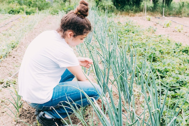 Free photo teenager tending scallions