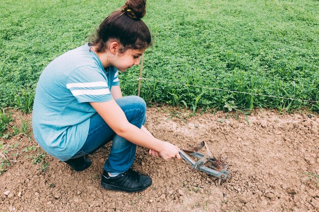 Teenager turn over soil