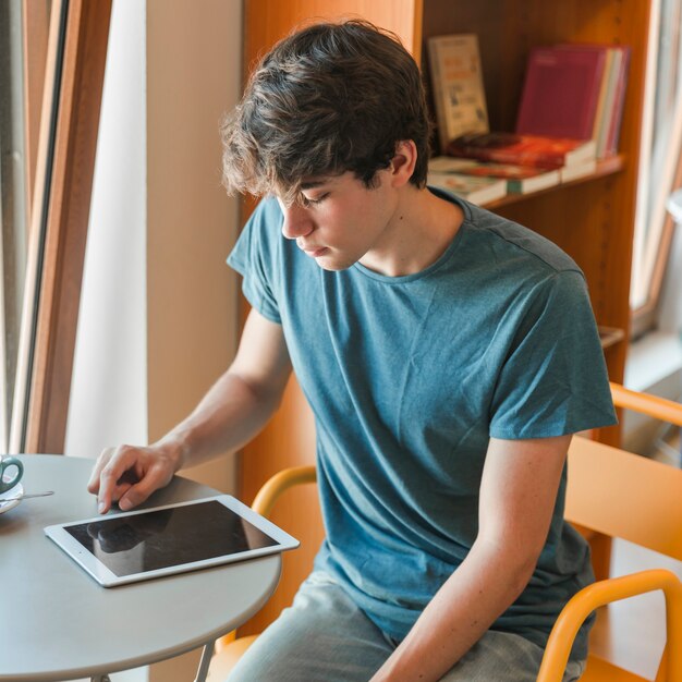 Teenager using tablet in library