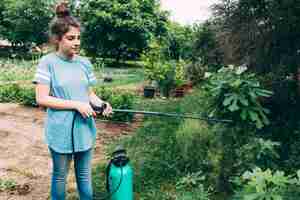 Free photo teenager watering garden plants