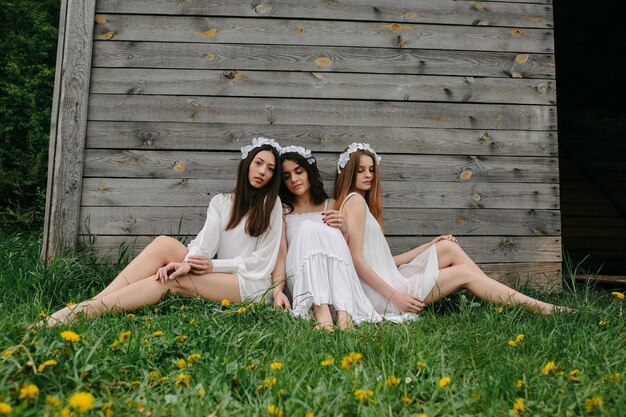 Teenager in white dress sitting on the lawn