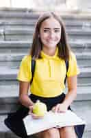 Free photo teenager with book and apple