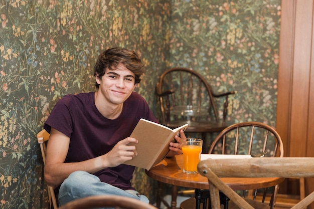 Teenager with book smiling 