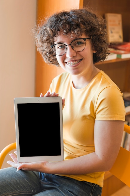 Teenager with braces showing tablet