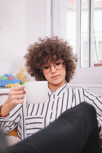 Teenager with mug of hot drink