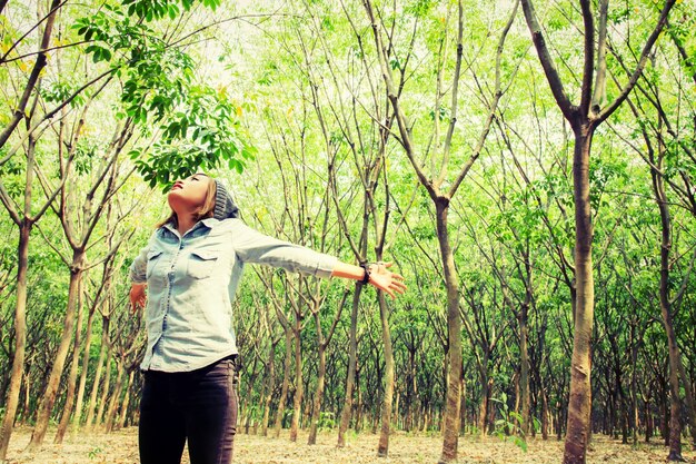 Teenager with open arms in nature