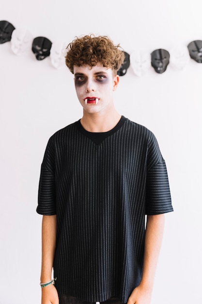 Free photo teenager with scary grim and fangs