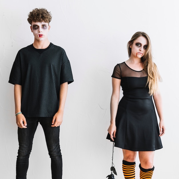 Teenagers in black clothes and frightening makeup 