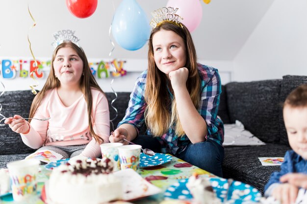 Teenagers eating birthday cake