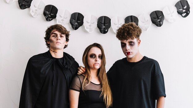 Teenagers in Halloween costumes of zombie and vampires