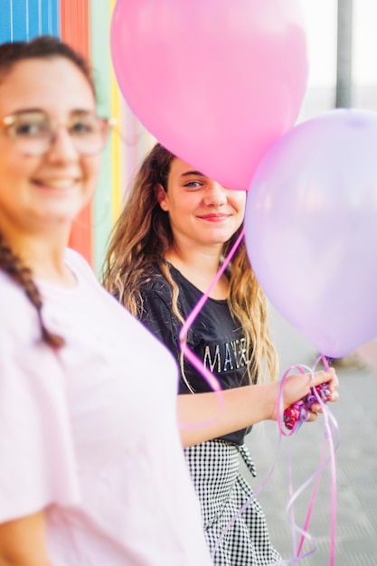 Teenagers holding balloons