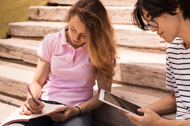 Teenagers learning together on stairs 