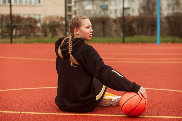 Teenagers posing at the basketball field