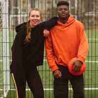 Free photo teenagers posing at the basketball field