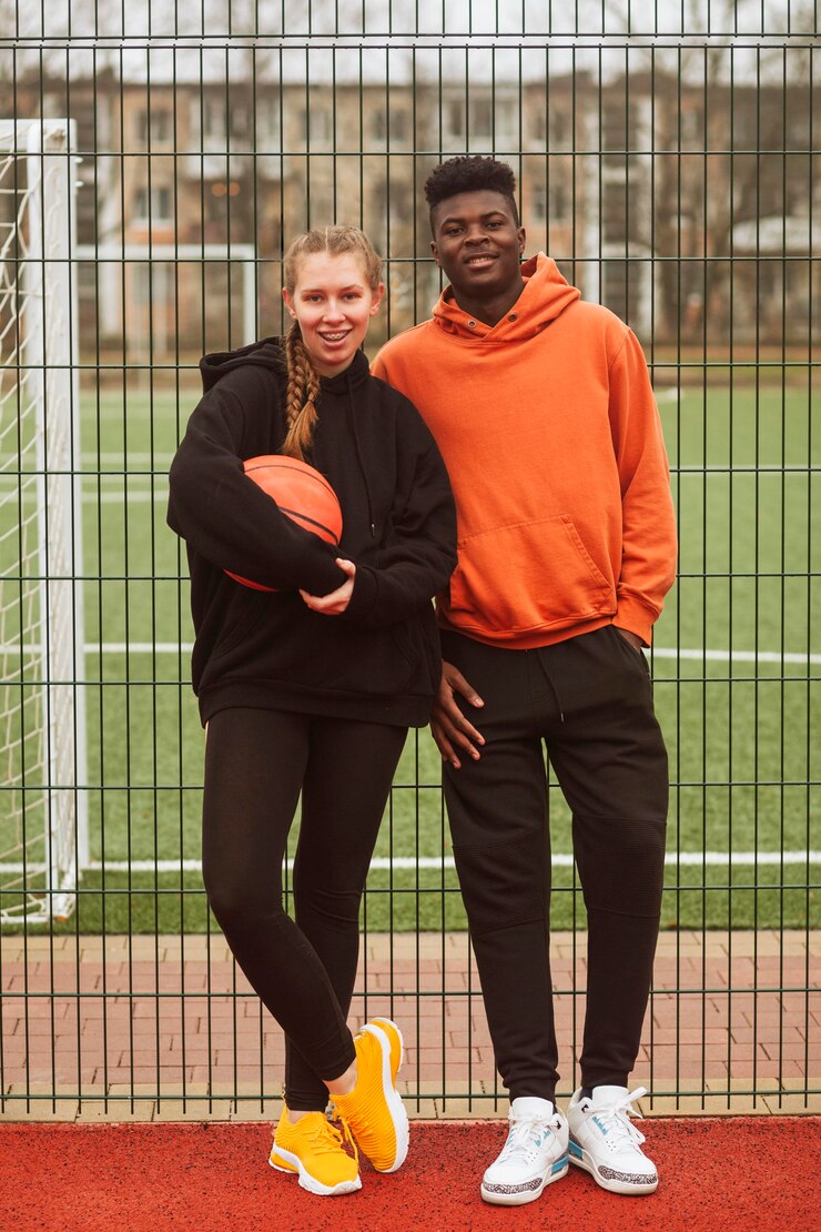 Free Photo teenagers posing at the basketball field