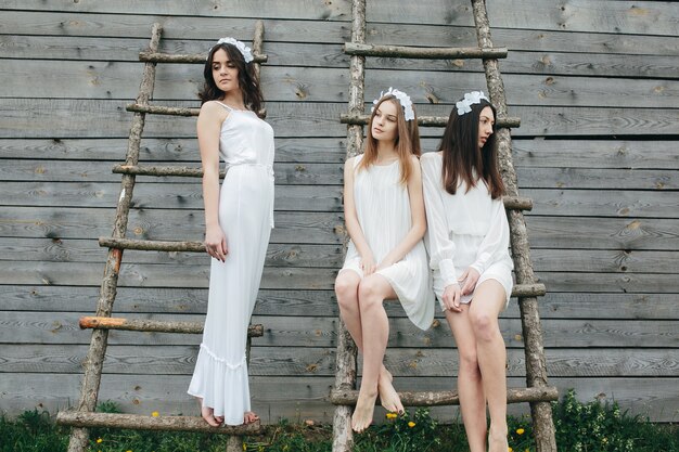 Teenagers posing in white dresses