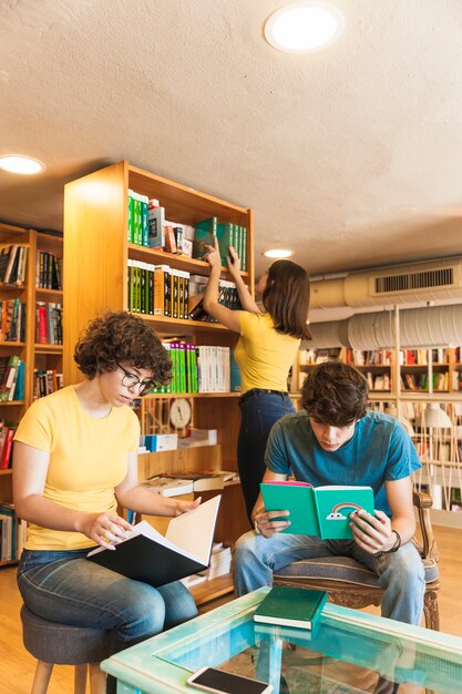 teenagers reading near friend choosing book