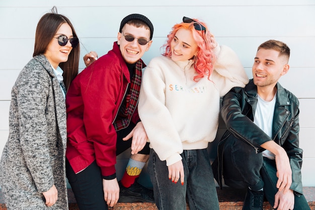 Teenagers sitting on bench and smiling