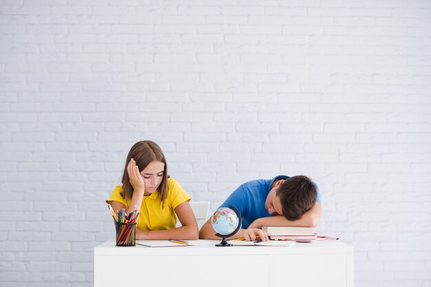 Teenagers sleeping in classroom