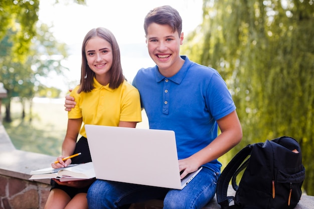 Teenagers studying in park