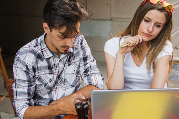 Teenagers studying with laptop