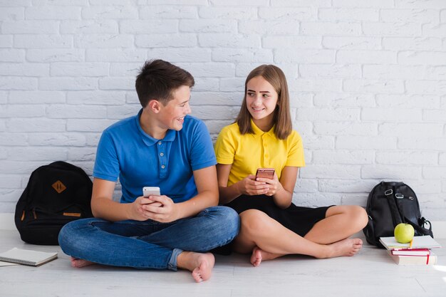 Teenagers using their smartphones