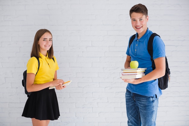 Teenagers with backpacks and notebooks