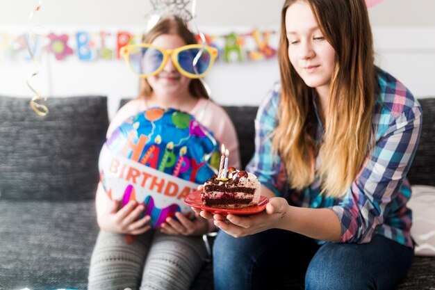 誕生日のケーキを持つティーンエイジャー