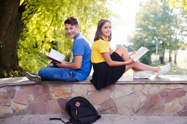 Teenagers with books in park