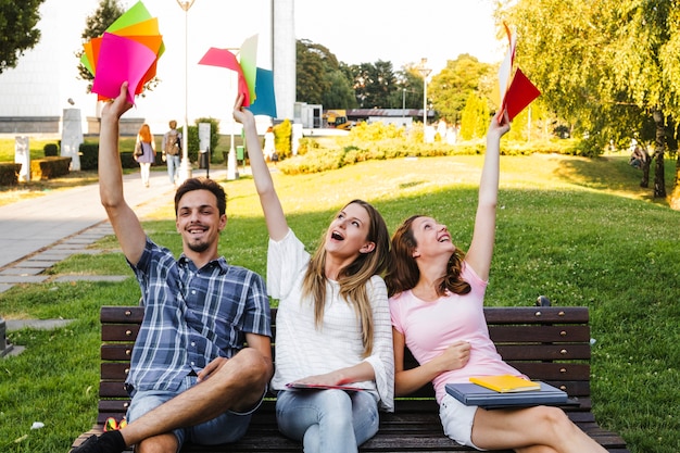 Free photo teenagers with colorful papers