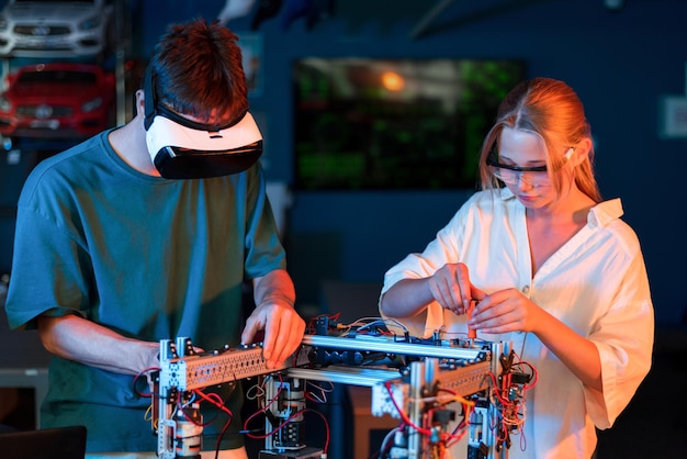 Free photo teens doing experiments in robotics in a laboratory boy in vr headset and girl in protective glasses