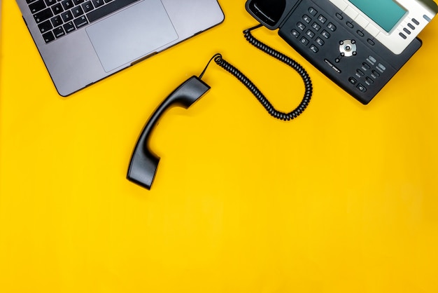Telephone, Laptop Flat lay with workspace on yellow background