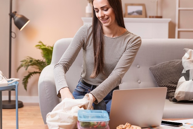 Free photo teleworking on laptop and lunch in boxes concept