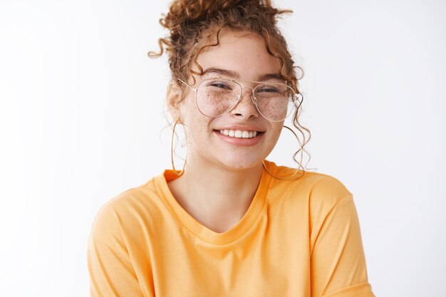 Tender happy smiling redhead cute 20s young girl wearing glasses giggling feeling joyful optimistic have lucky day standing amused full energy white background, having fun chilling party