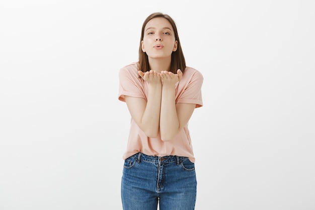 空気のキスを送る優しい笑顔の女性