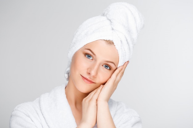 Tender smiling woman touching clean face